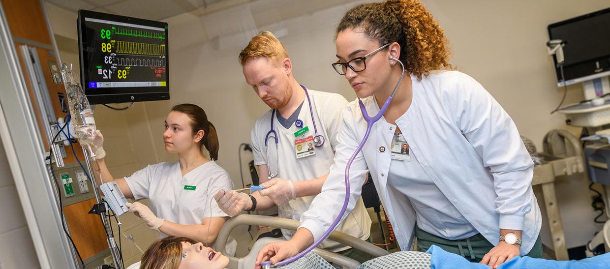 Nursing students working on a patient